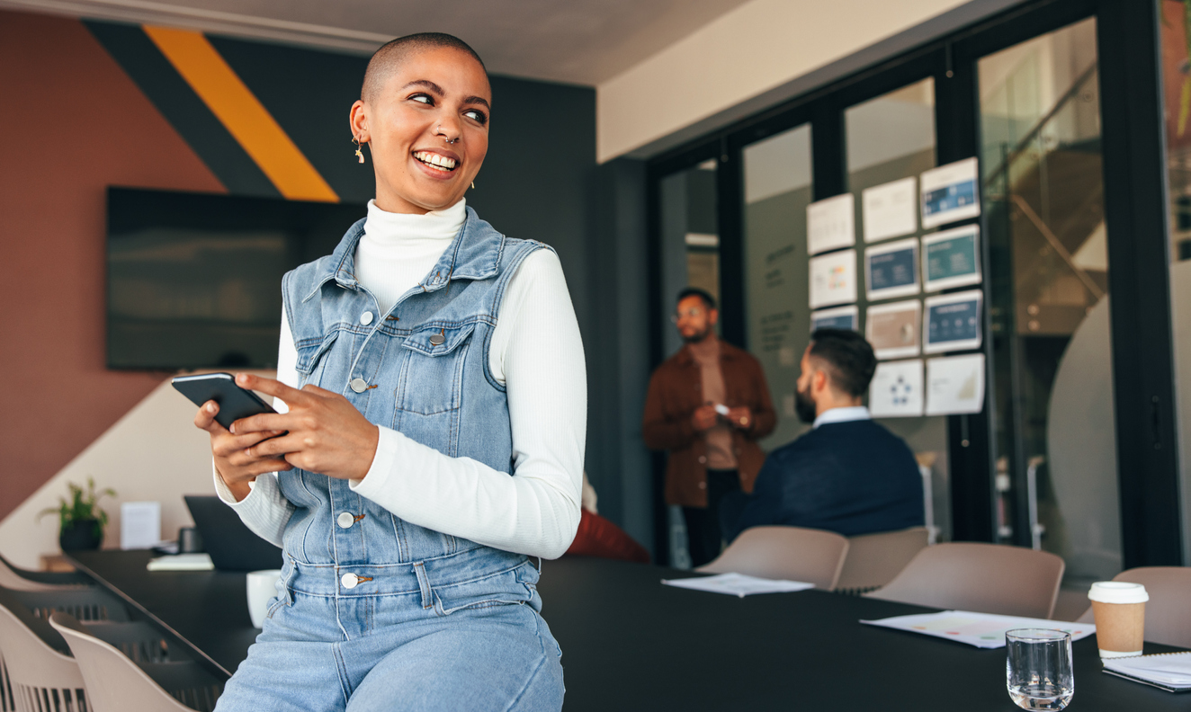 Women in office on phone smiling