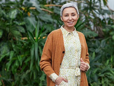 Woman with brown cardigan in garden