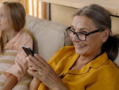 Woman on couch holding mobile phone