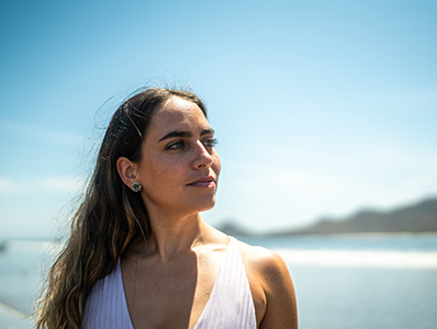 Woman at the beach looking into the distance