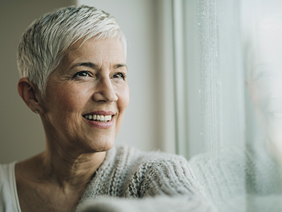 Woman with grey hair wearing a woollen jumper