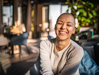 Woman with short hair in a cafe laughing