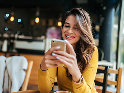 Woman in a bar sending a text message