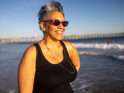 Person on beach smiling in sun