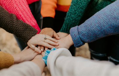 People with hands in middle
