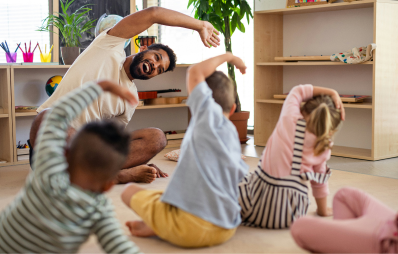 Child care educator and children doing yoga