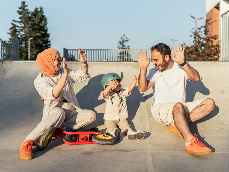 Young family at skate park square