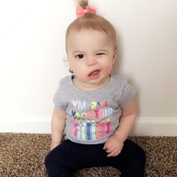 Toddler with a pink bow in her hair