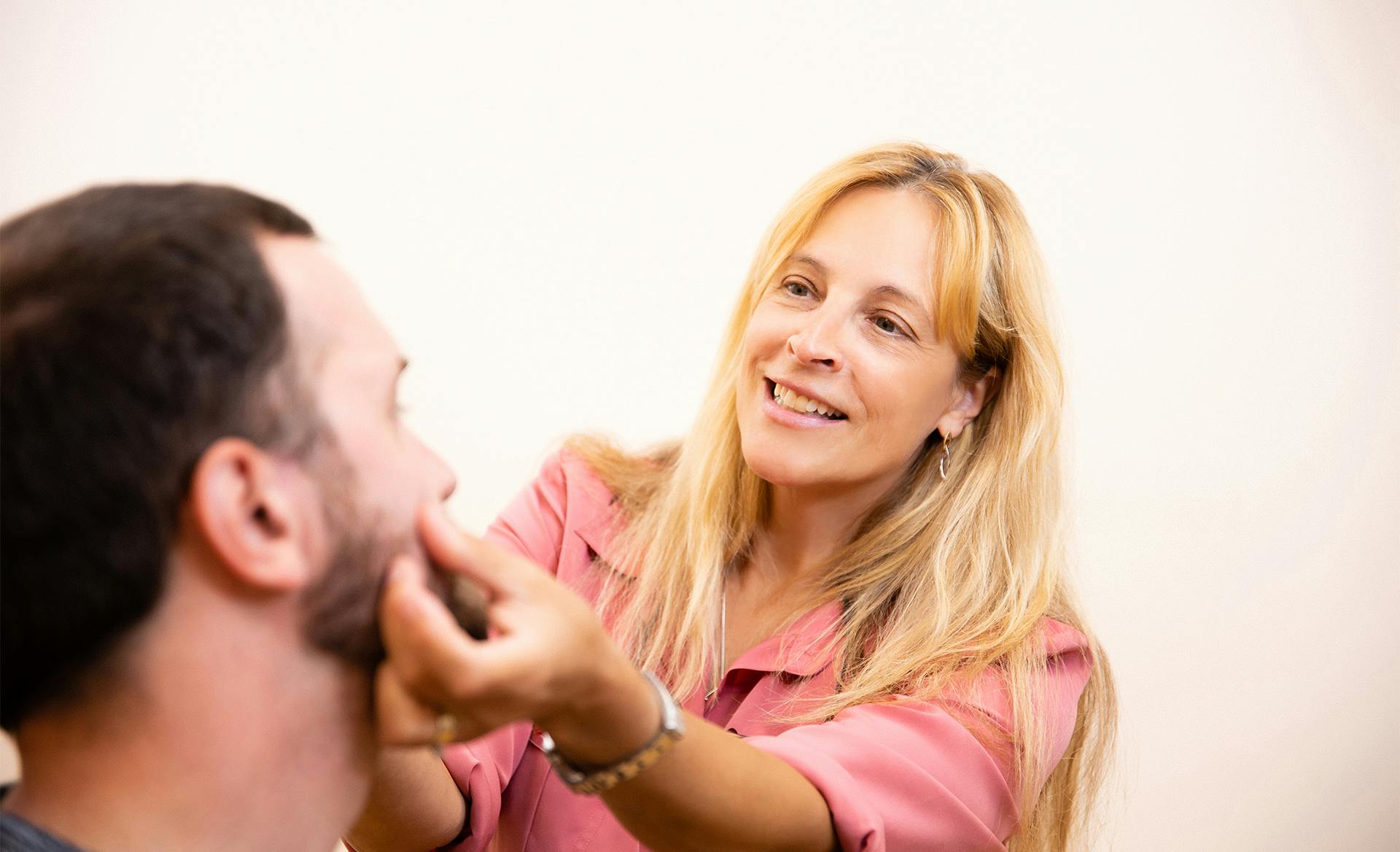 doctor checking facial muscles