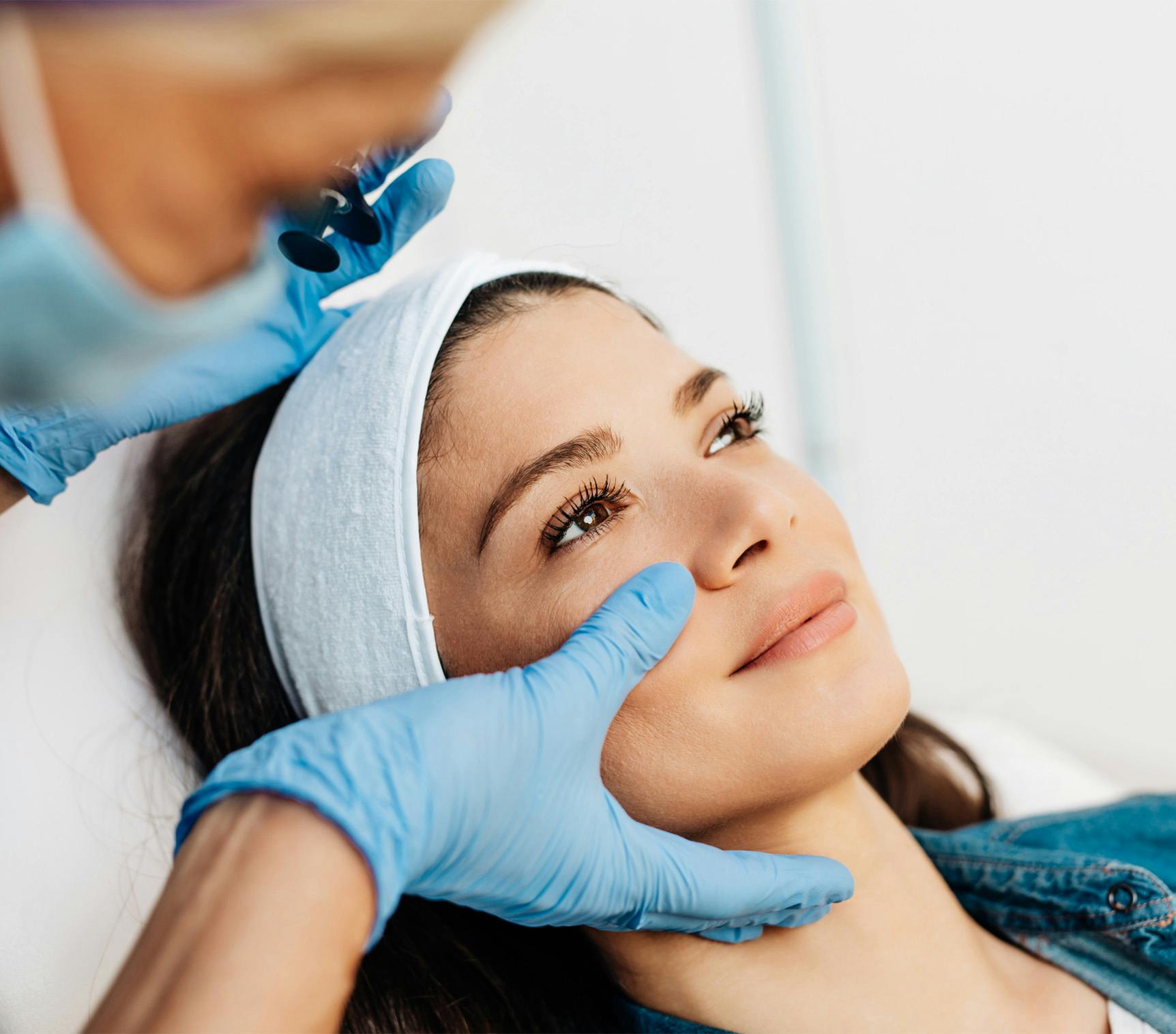 woman getting face examined