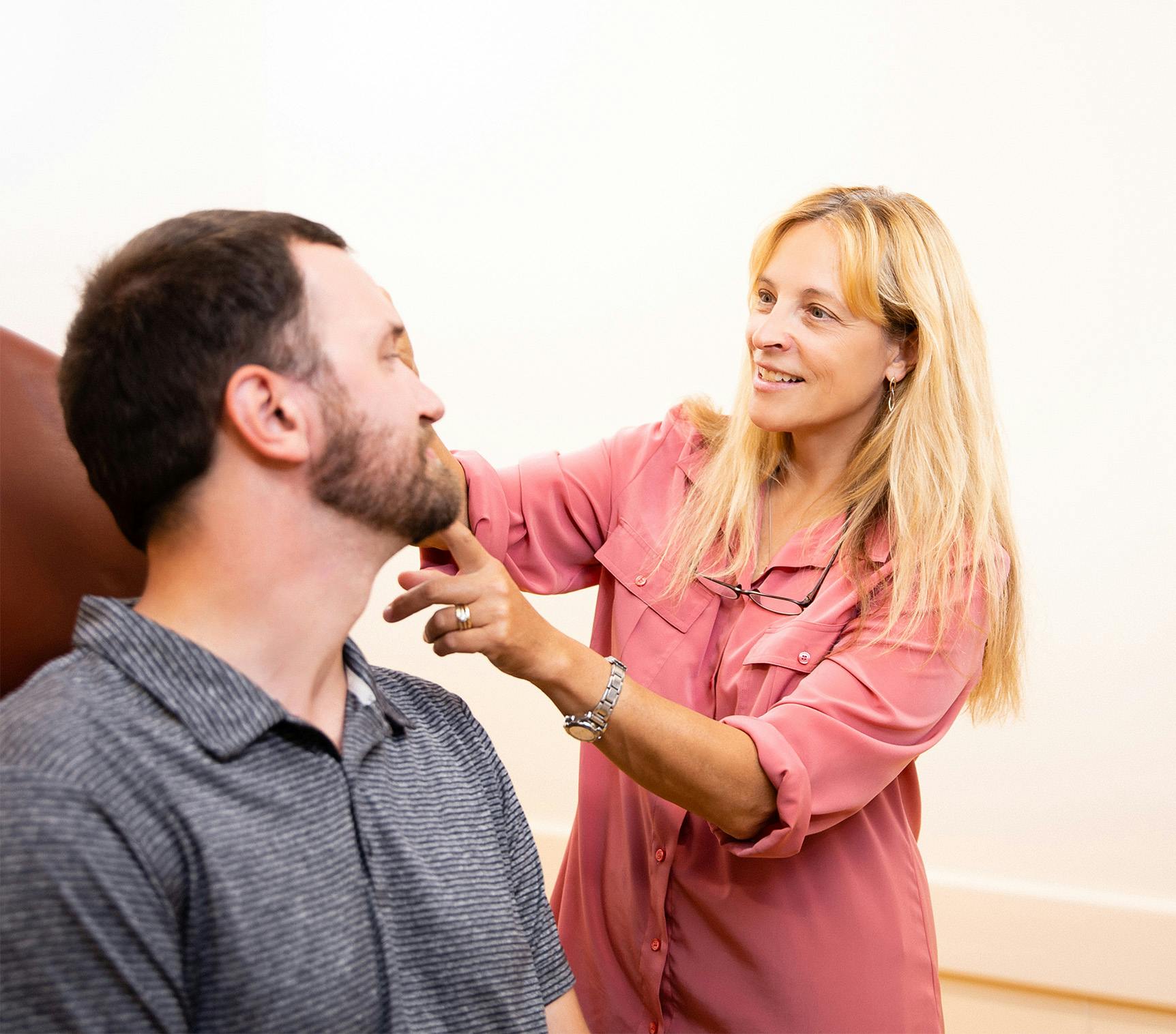 doctor working with patient in chair