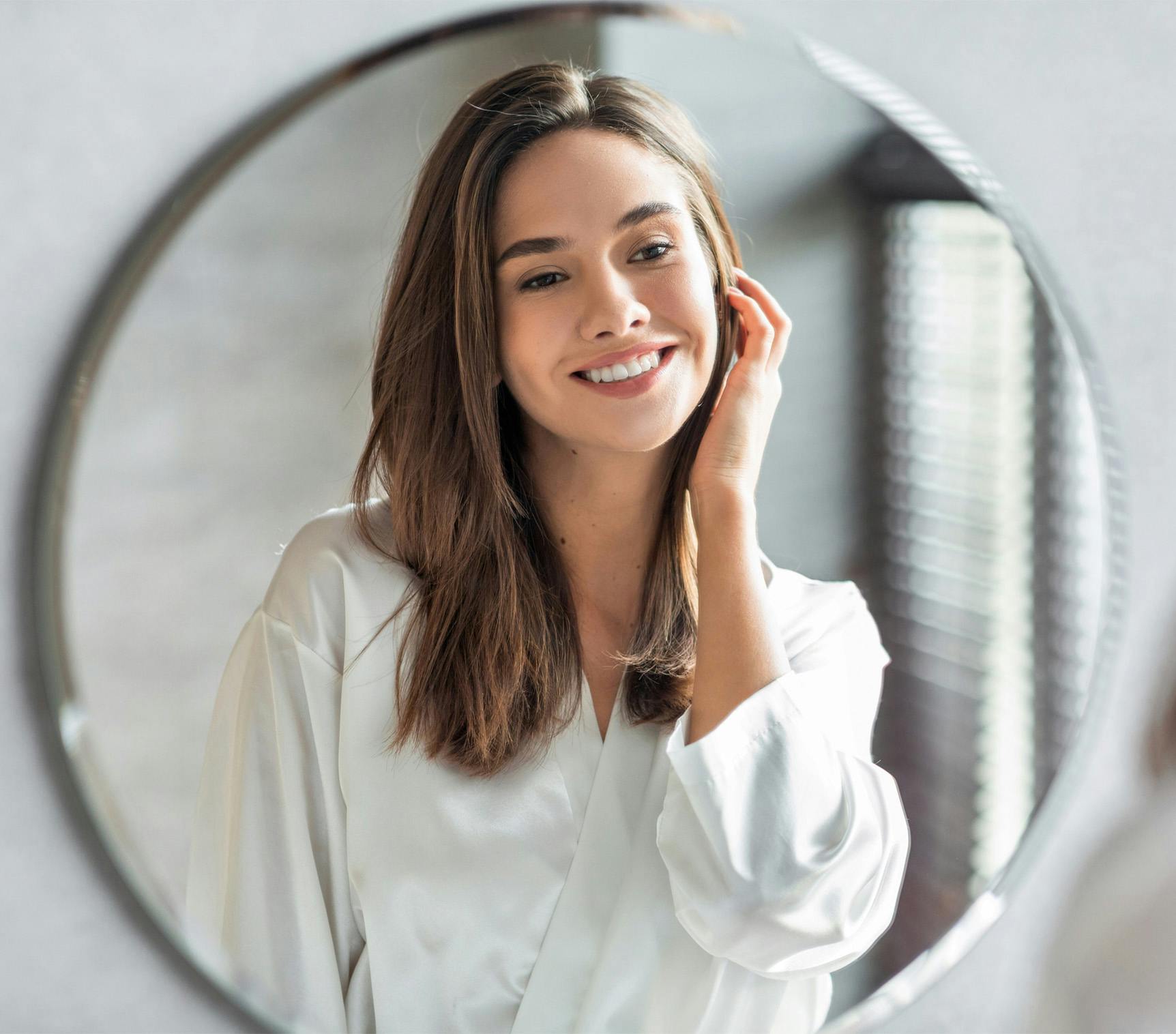 woman looking at herself in mirror