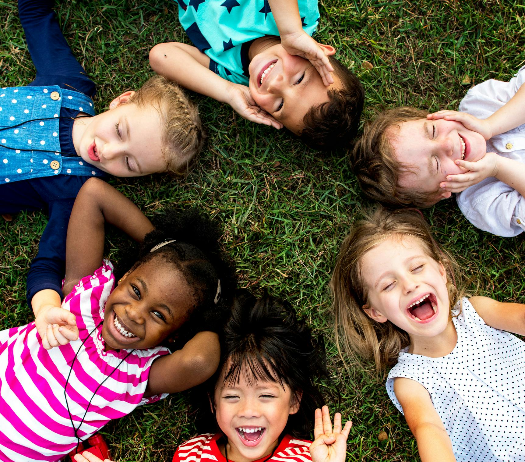 kids laying in grass