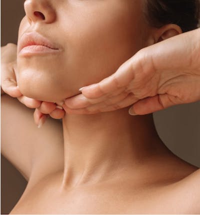 Woman with her hand on her neck