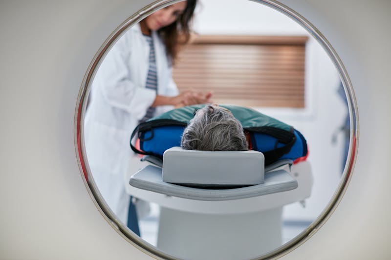 Man lying on an MRI table during a medical imaging scan