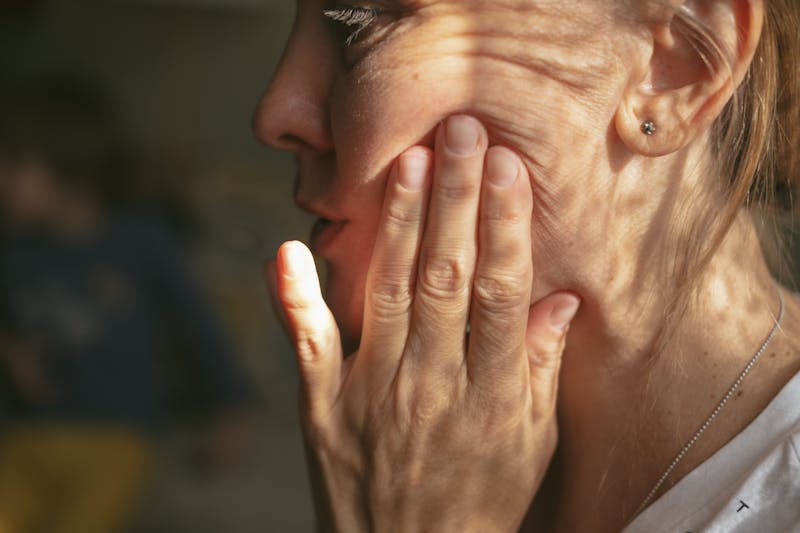 Woman touching her face
