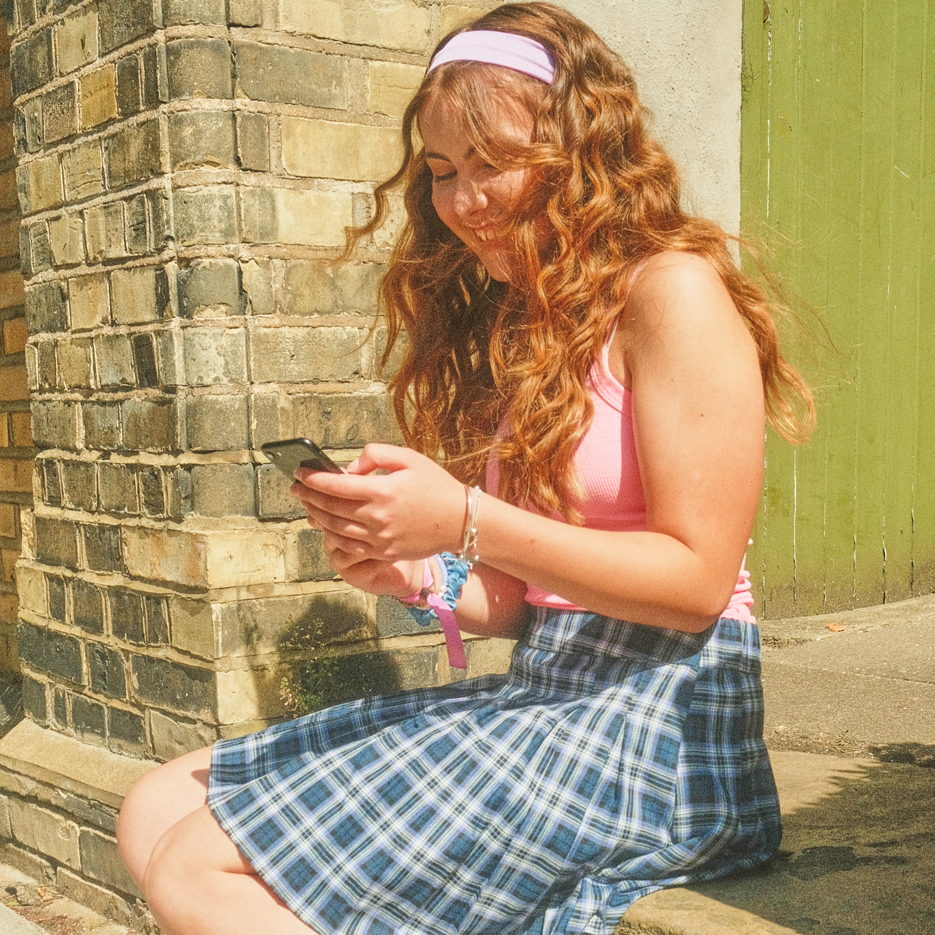 Smiling teen girl looking at phone