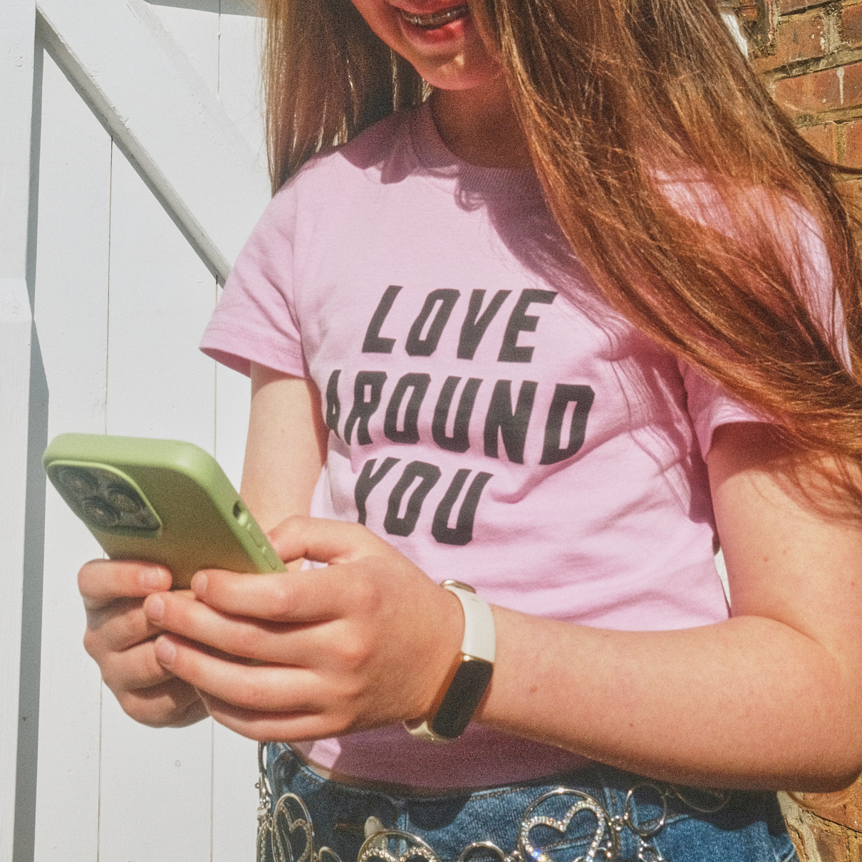 teen looking down at phone