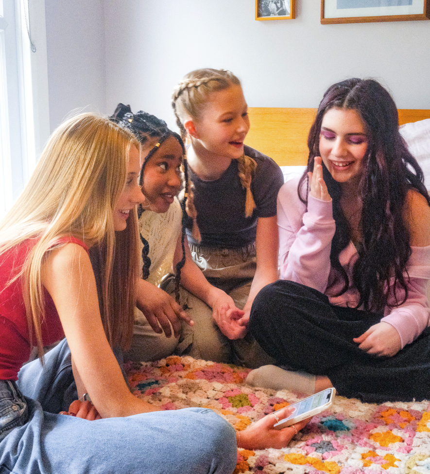 teens gathered around looking at luna app