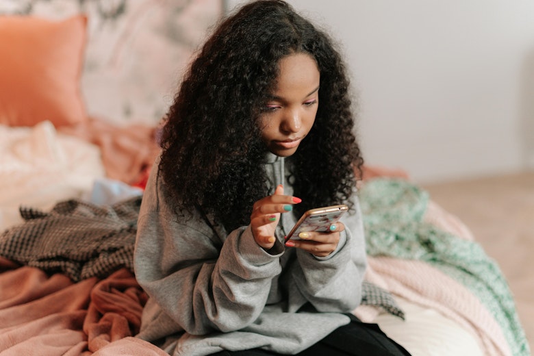 teen girl looking at phone