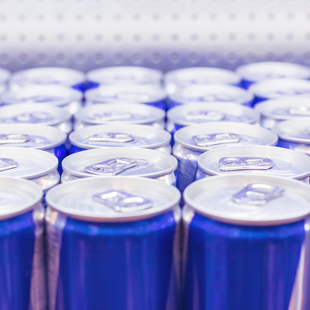 Rows of unlabelled blue energy drink cans lined up together.