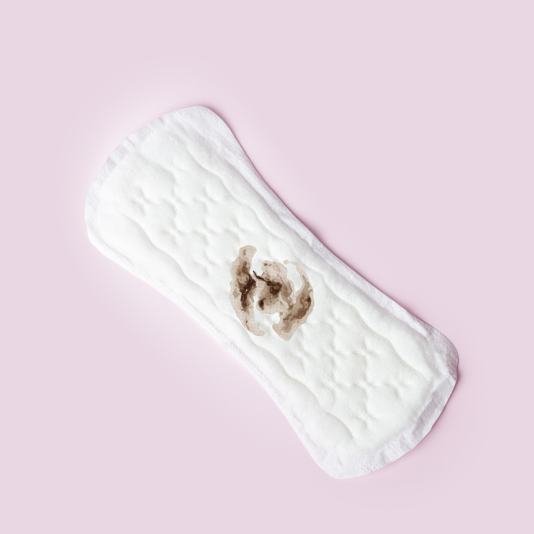 A period pad on a pink background showing a brown discharge stain.