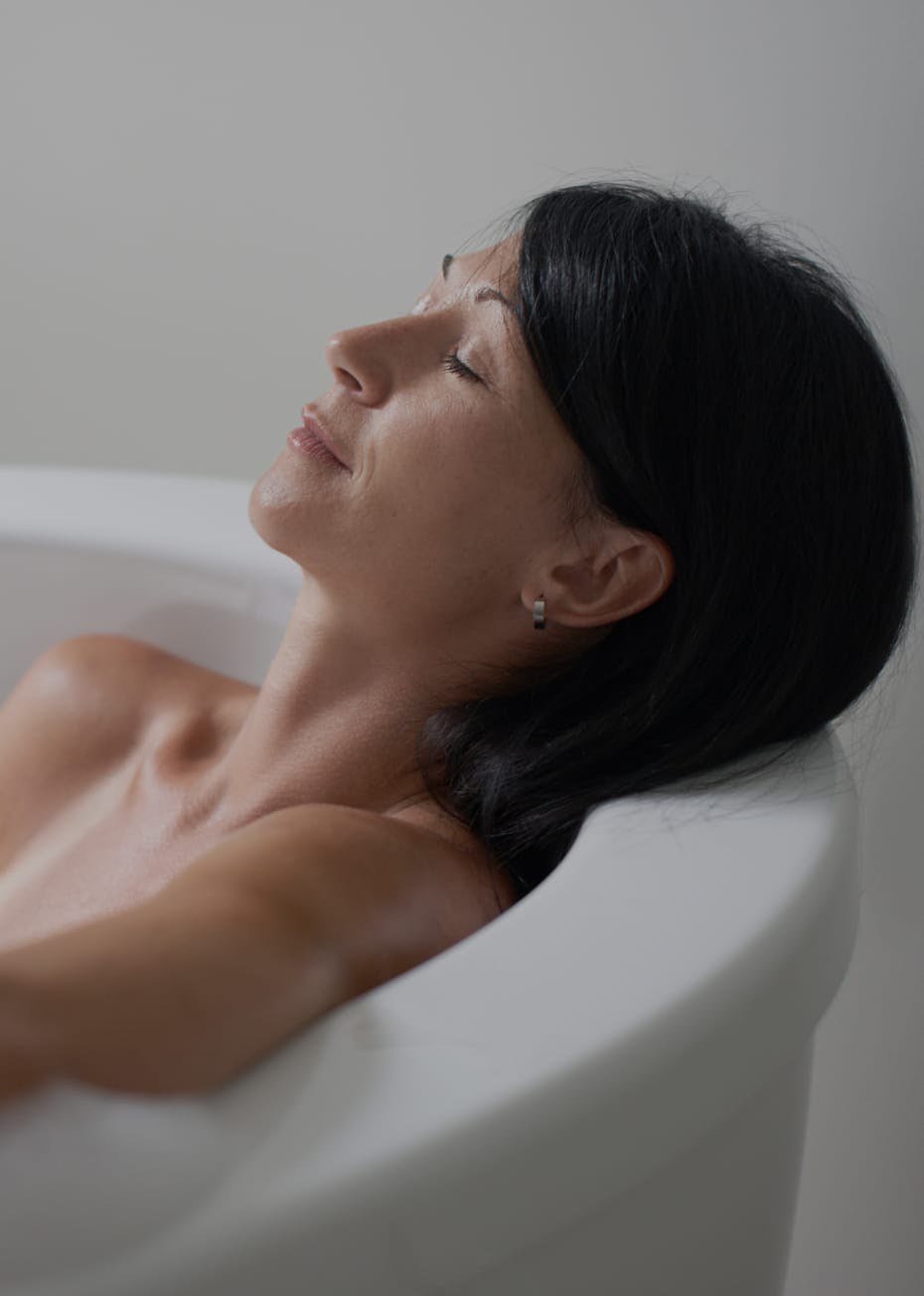 Woman relaxing in a bath tub