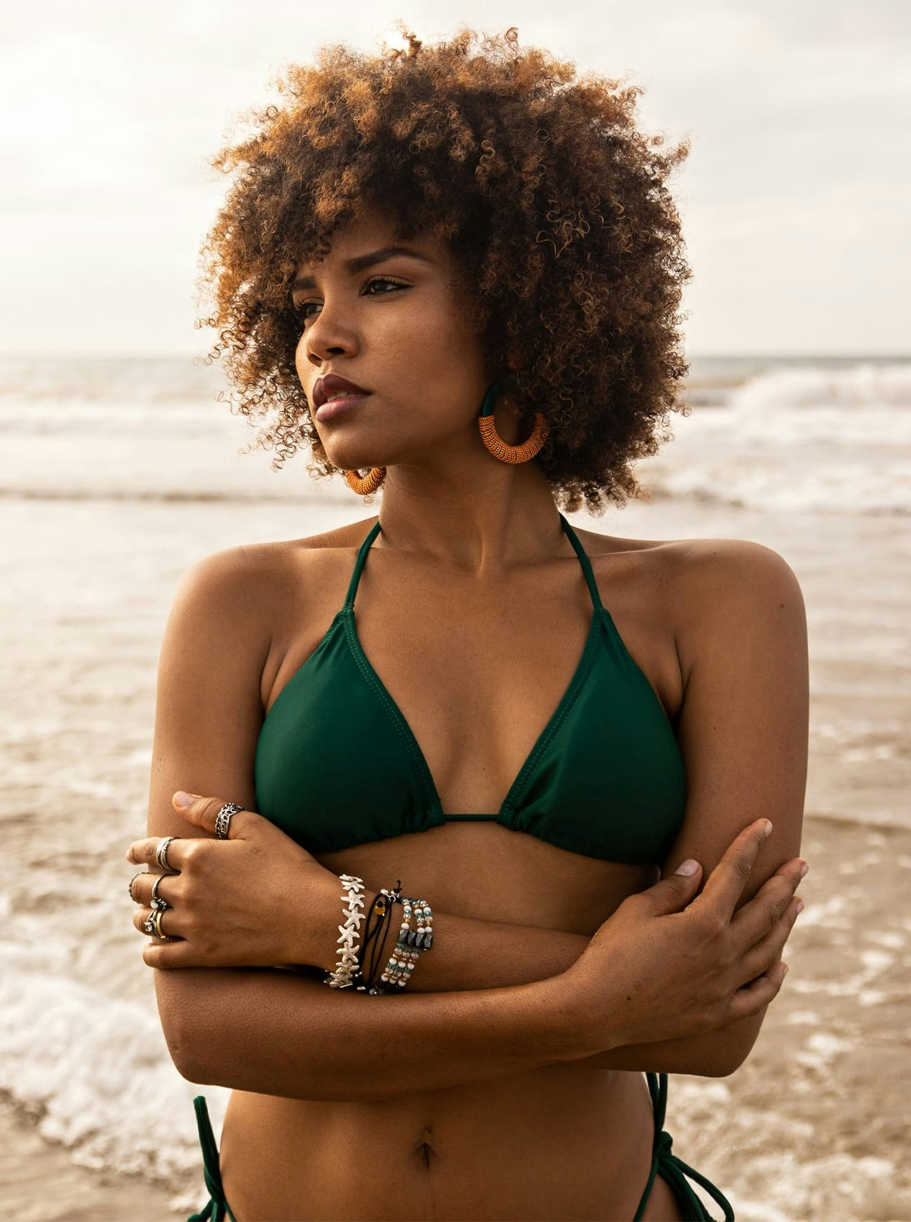 Woman in green bikinni modeling on beach