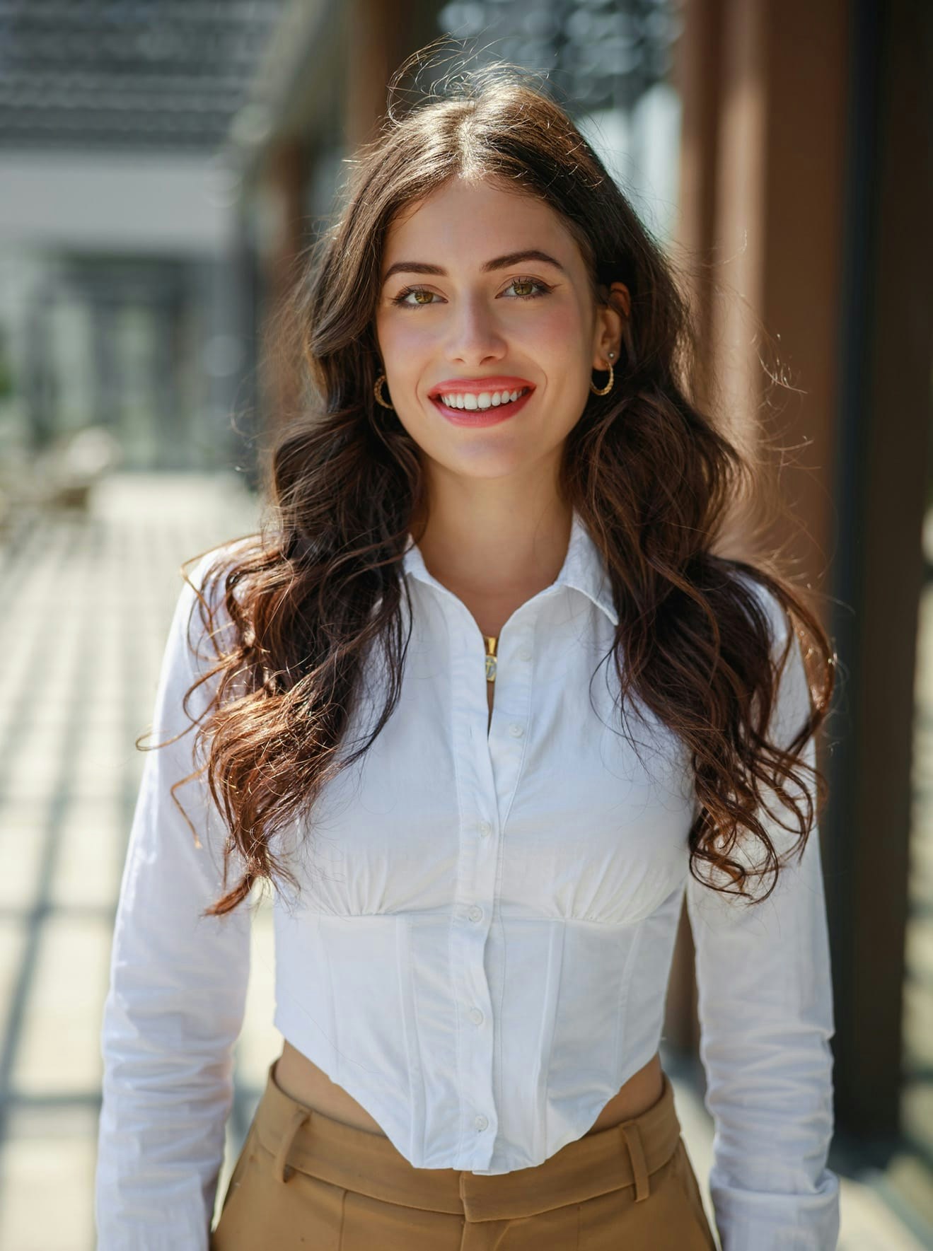 Woman in white blouse smling in sun