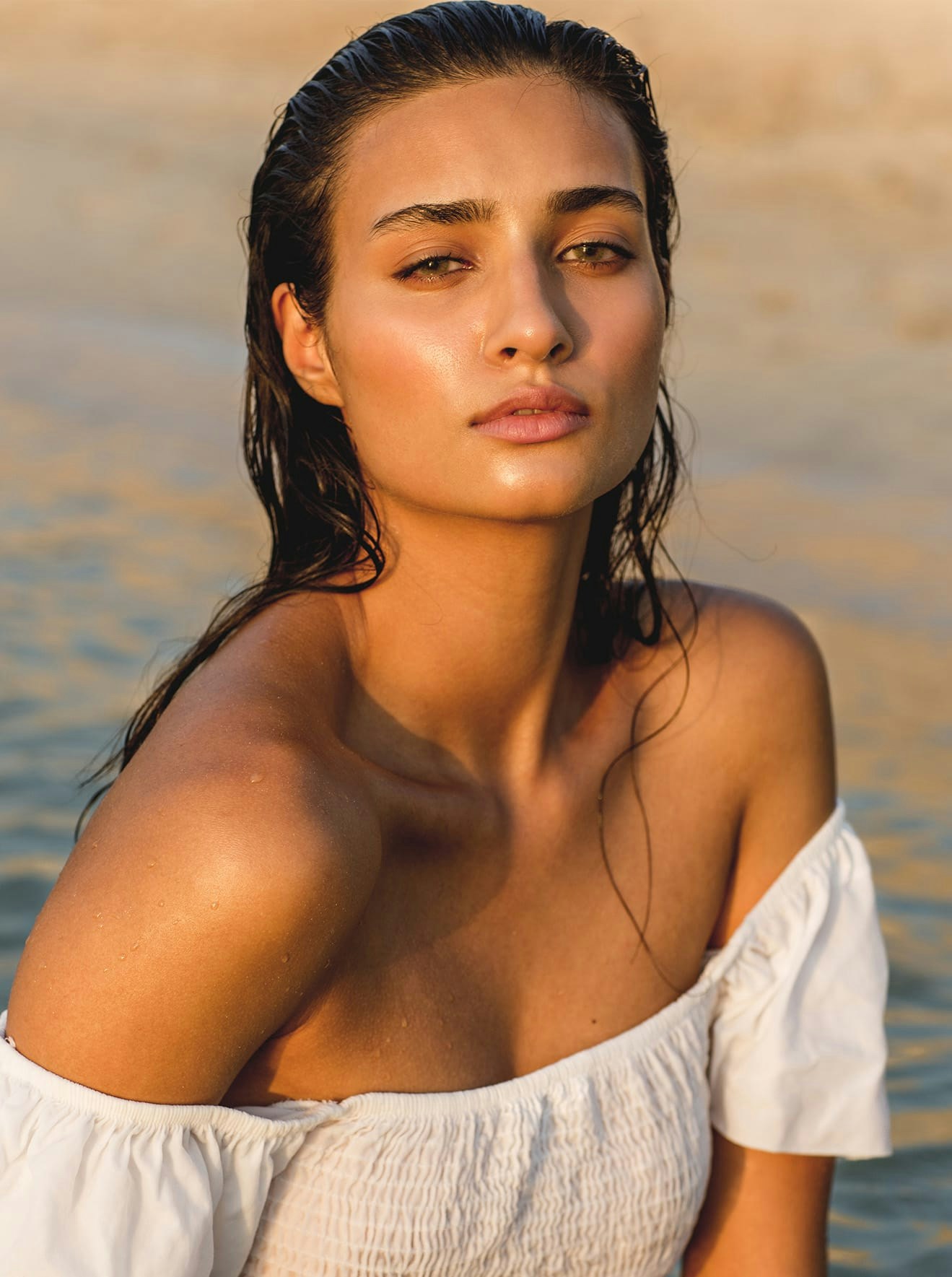 Woman in strapless white blouse in the water