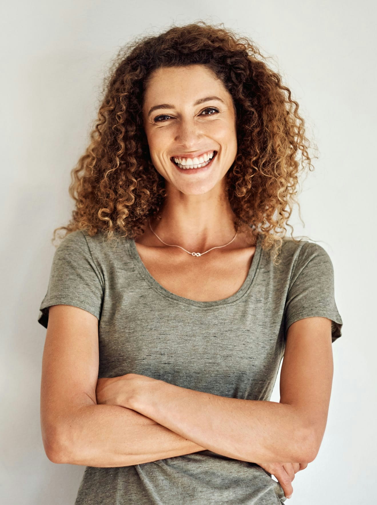 Woman with arms crossed and smiling