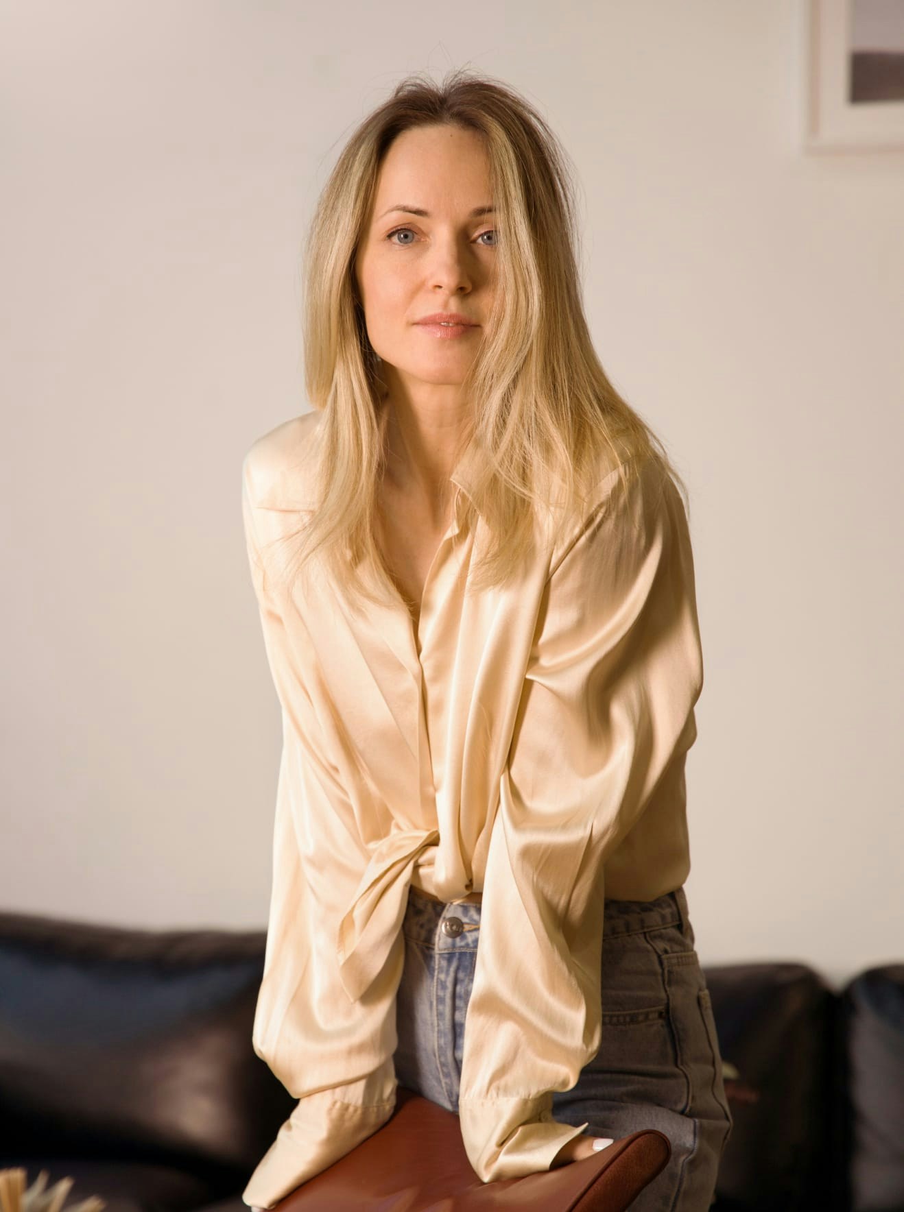 Woman in a silk blouse leaning over