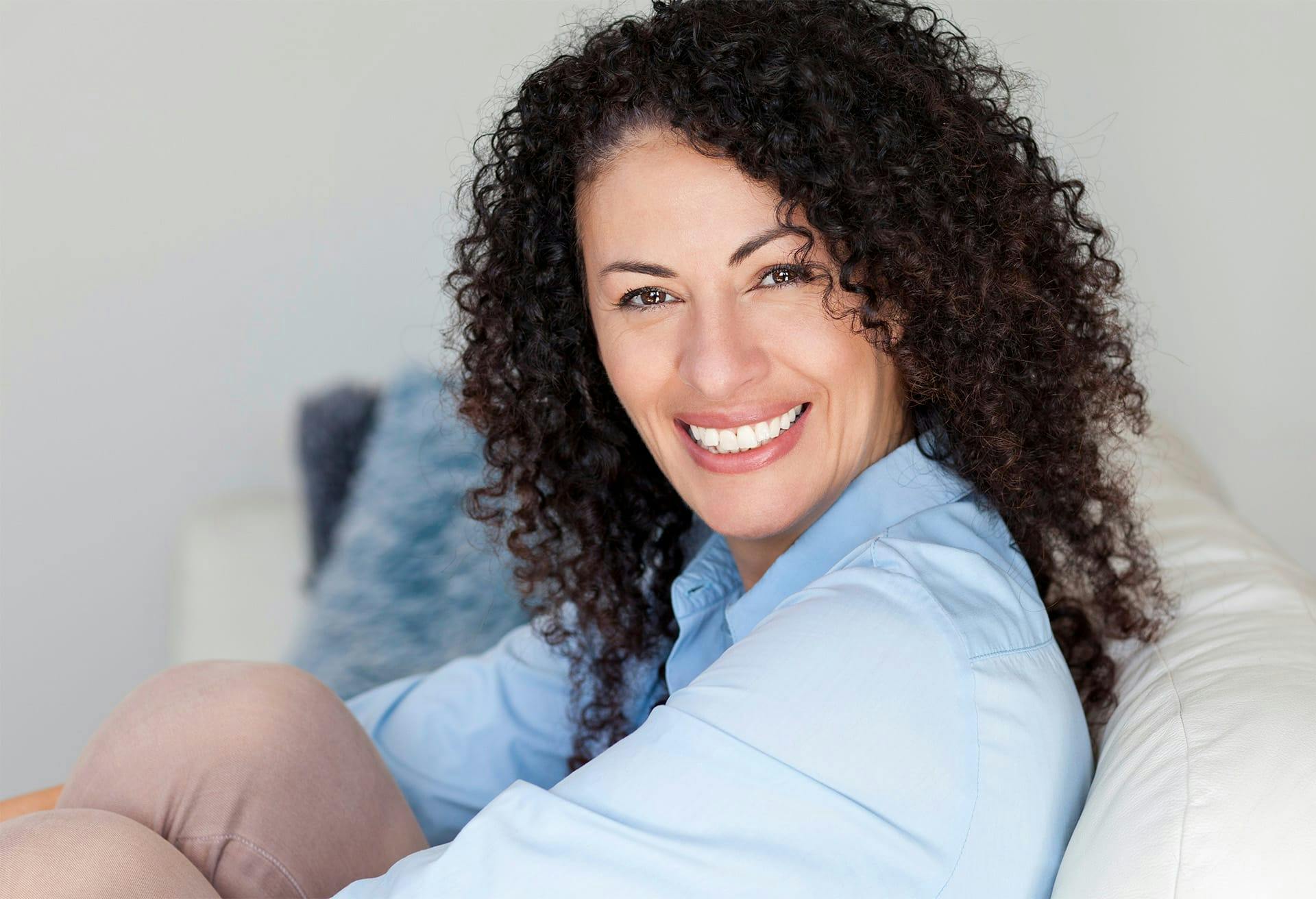 Woman in blue shirt smiling