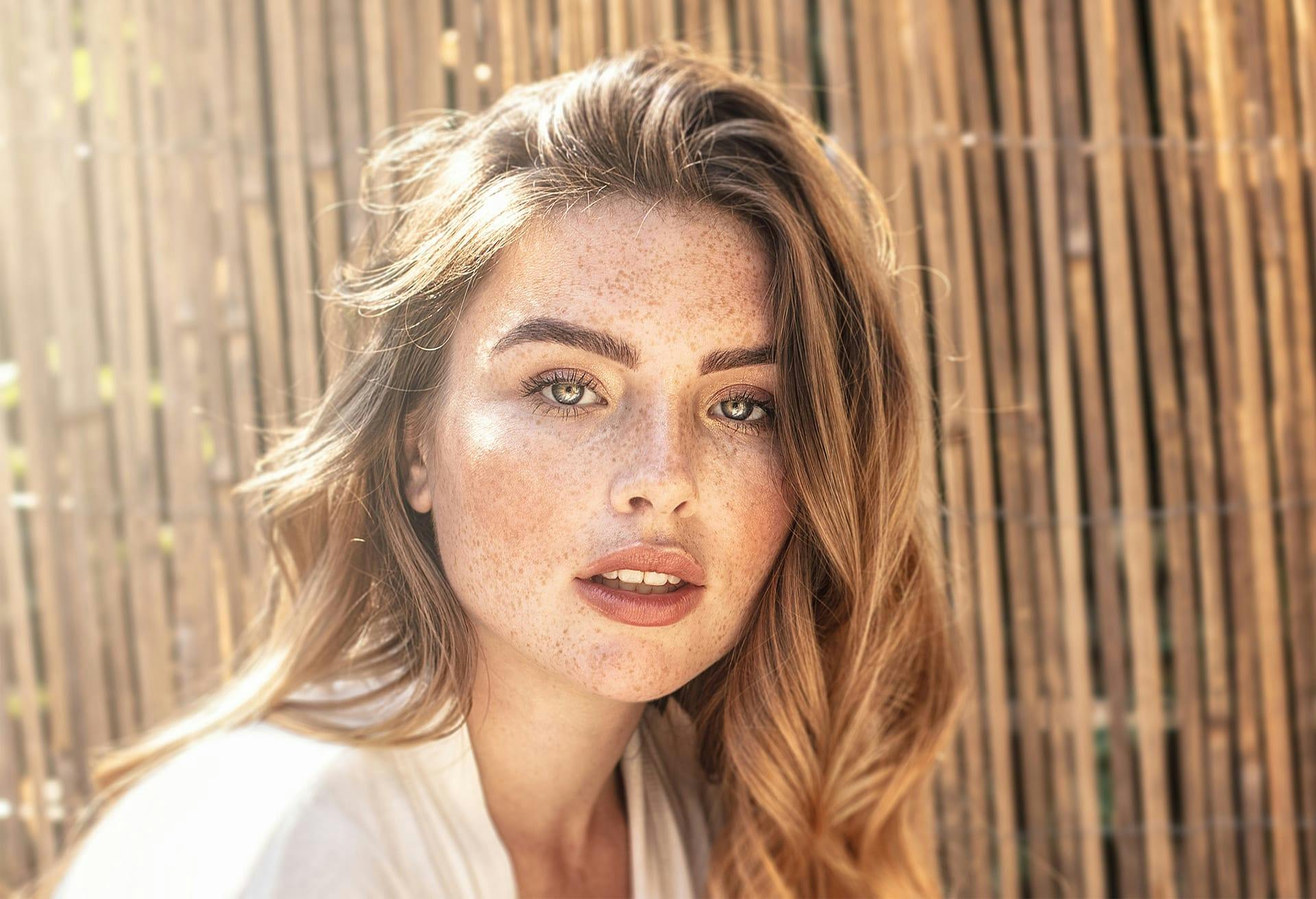 Woman in white blouse and lots of freckles