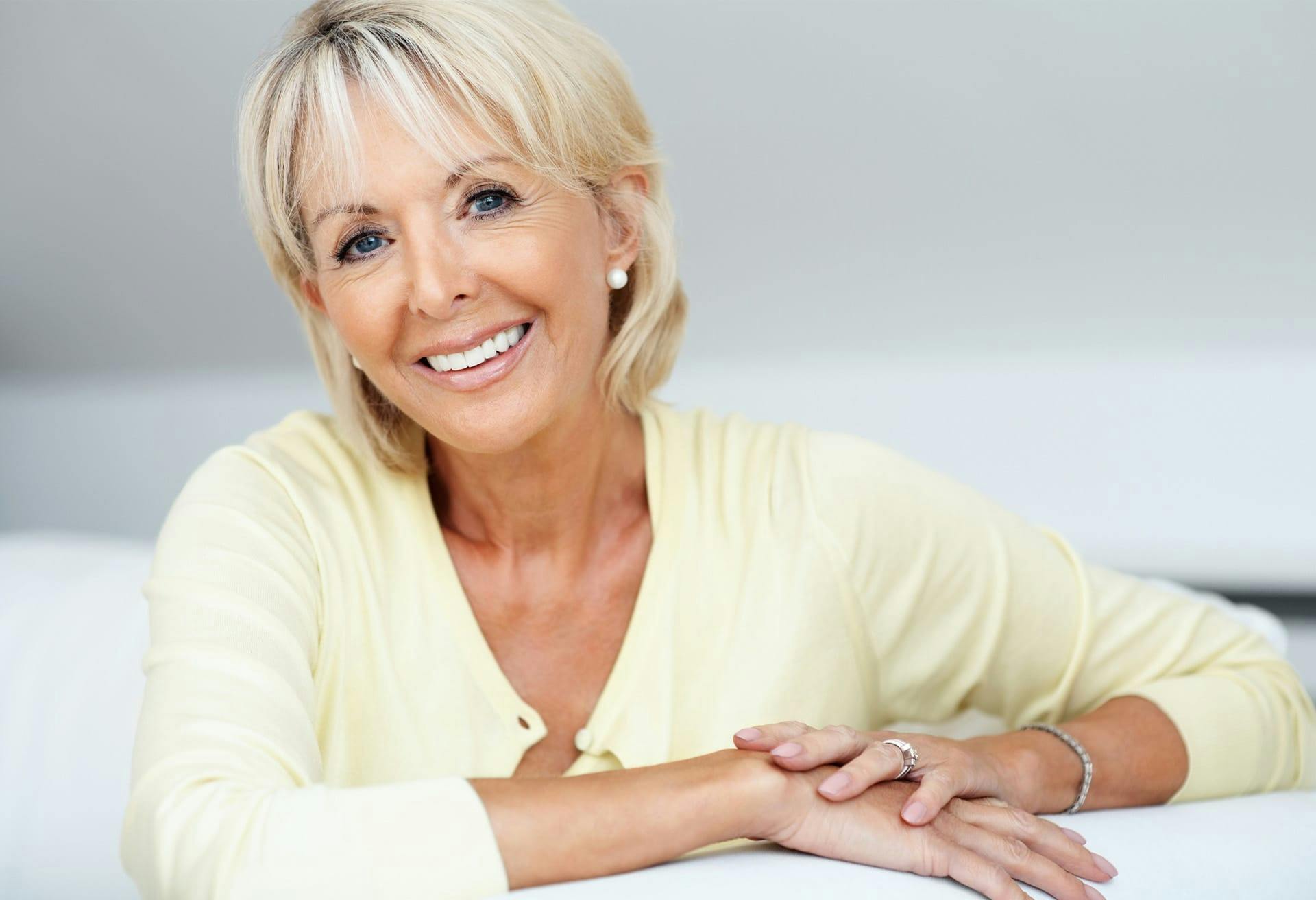 Woman in yellow shirt smiling