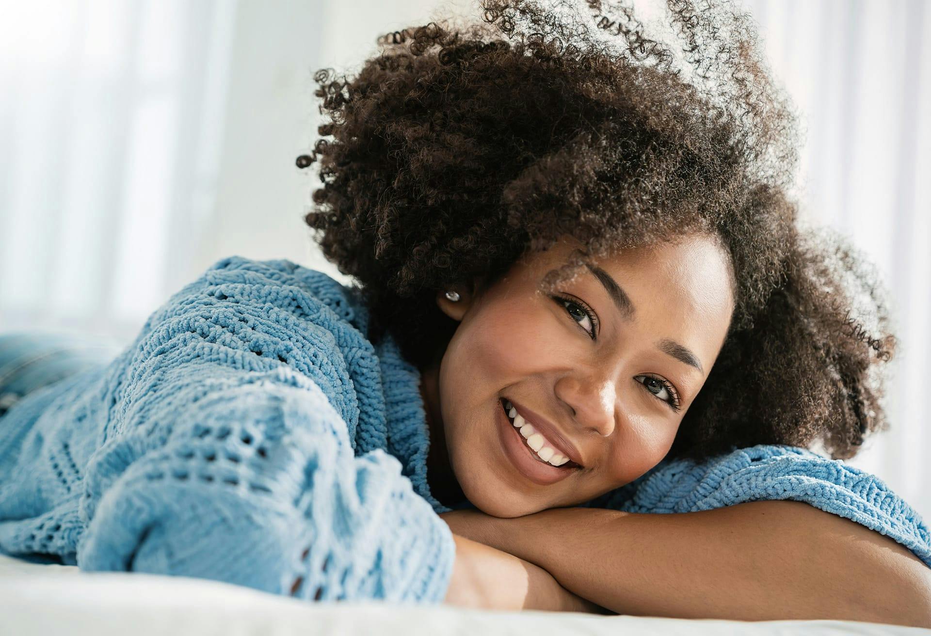 Woman in blue sweater smling