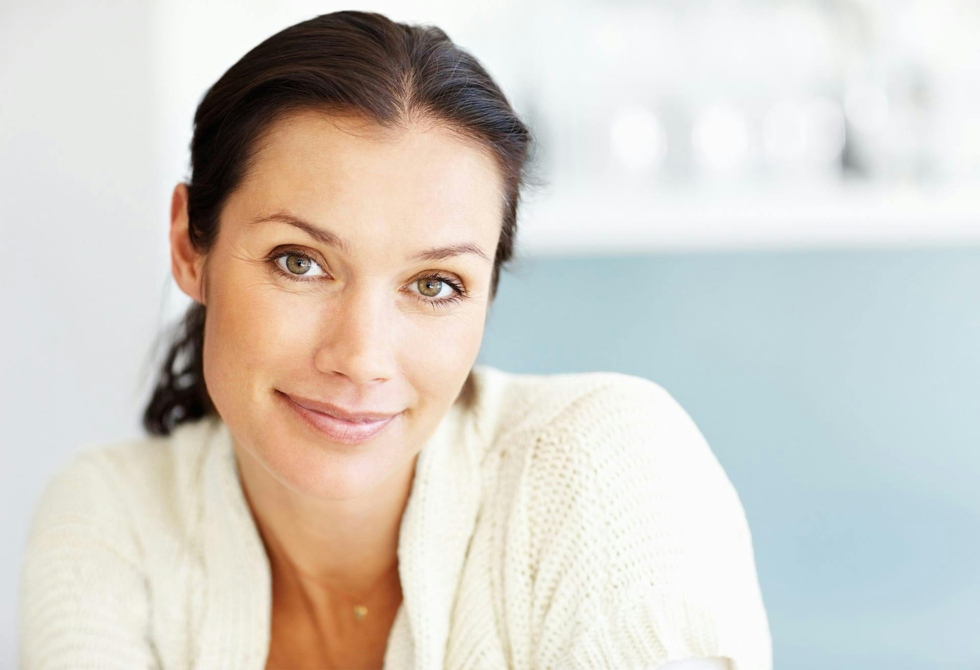 Woman with white sweater smiling
