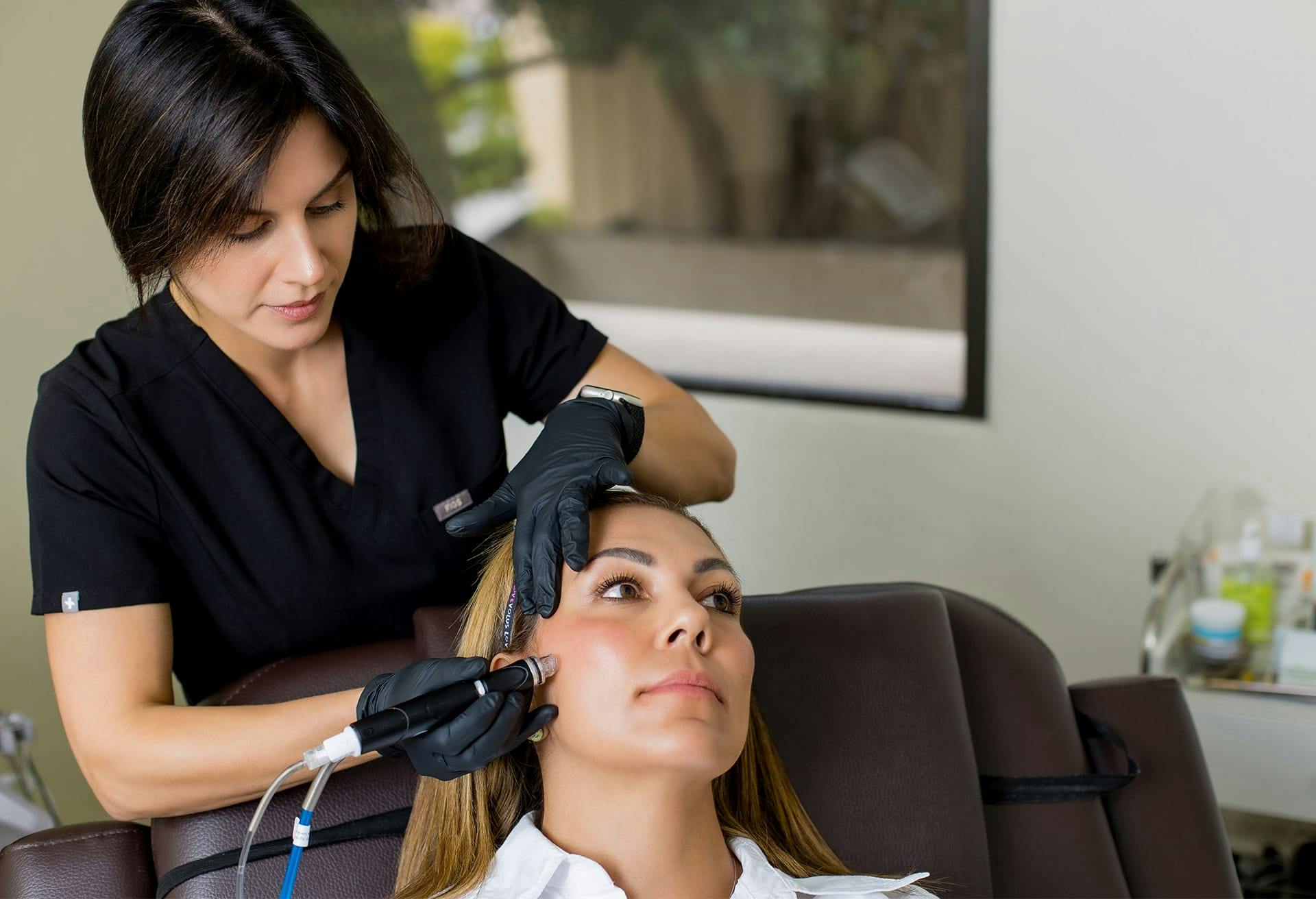 Woman getting facial treatment at Dr. Bolitho's