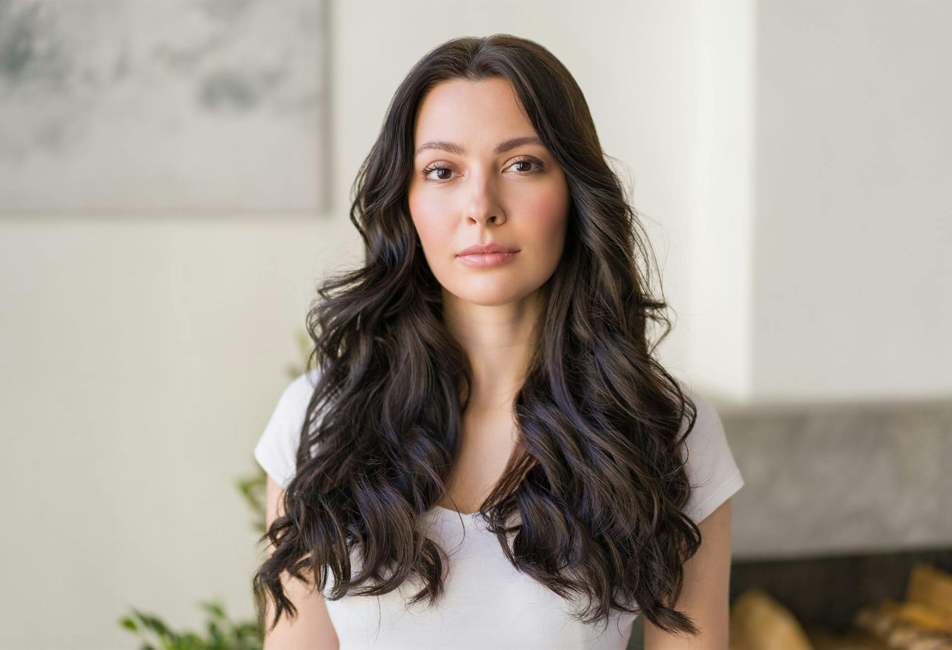 Woman in white shirt standing in living room