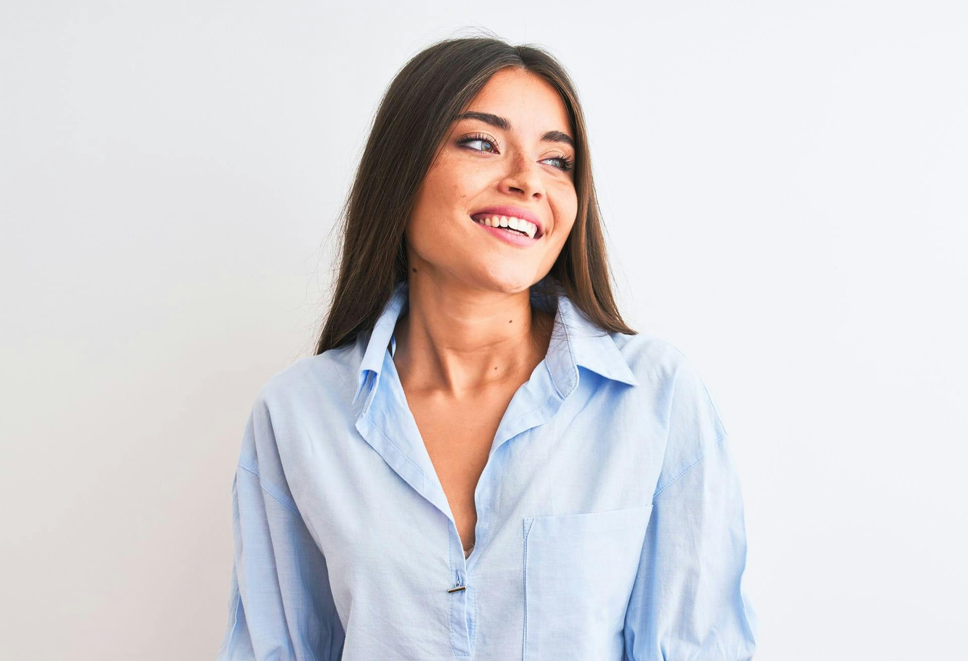 Woman in blue button up smiling