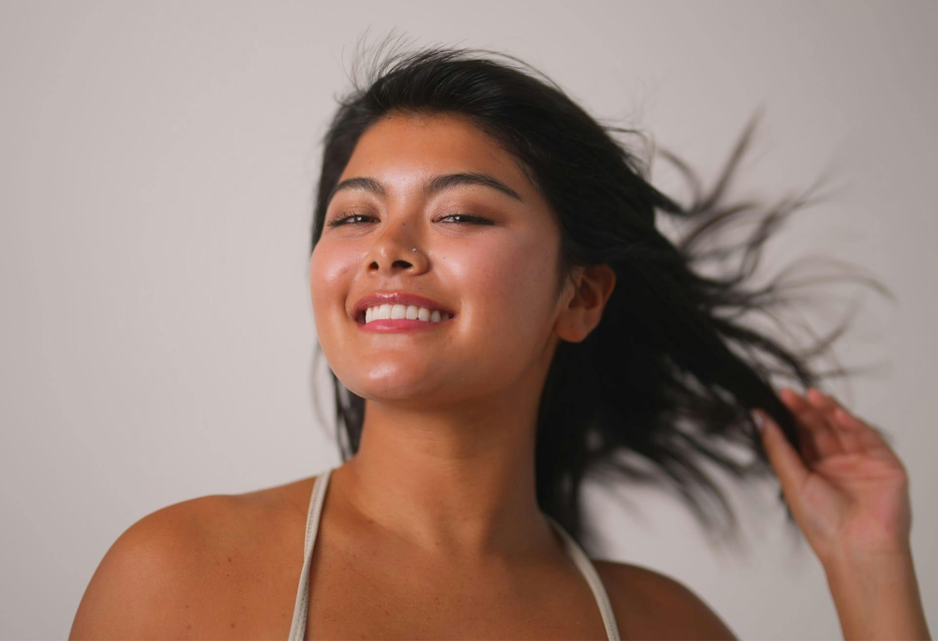 Woman smiling with hair in the wind