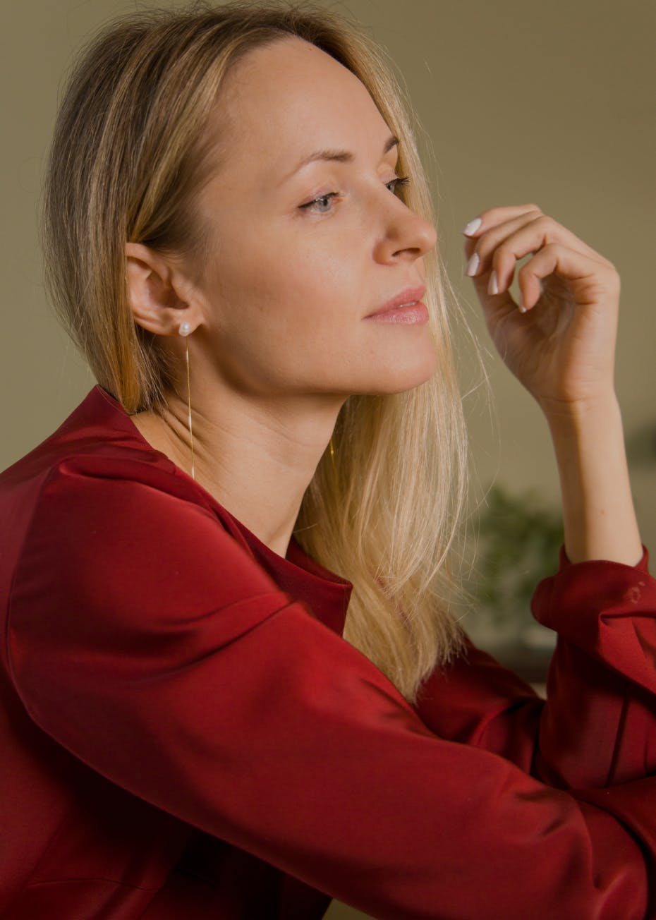 Woman standing under a palm tree at the beach