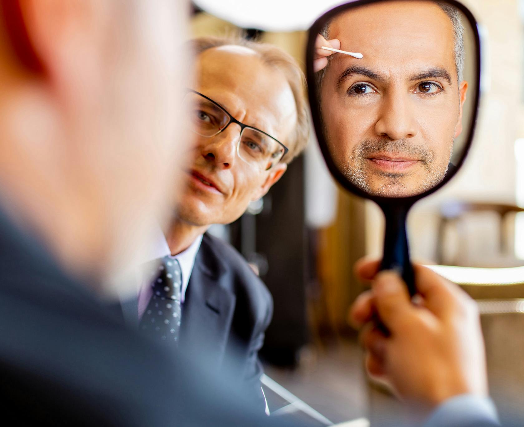 there is a man looking at himself in the mirror with Dr. Wojciech Przylecki from Lavie Institute