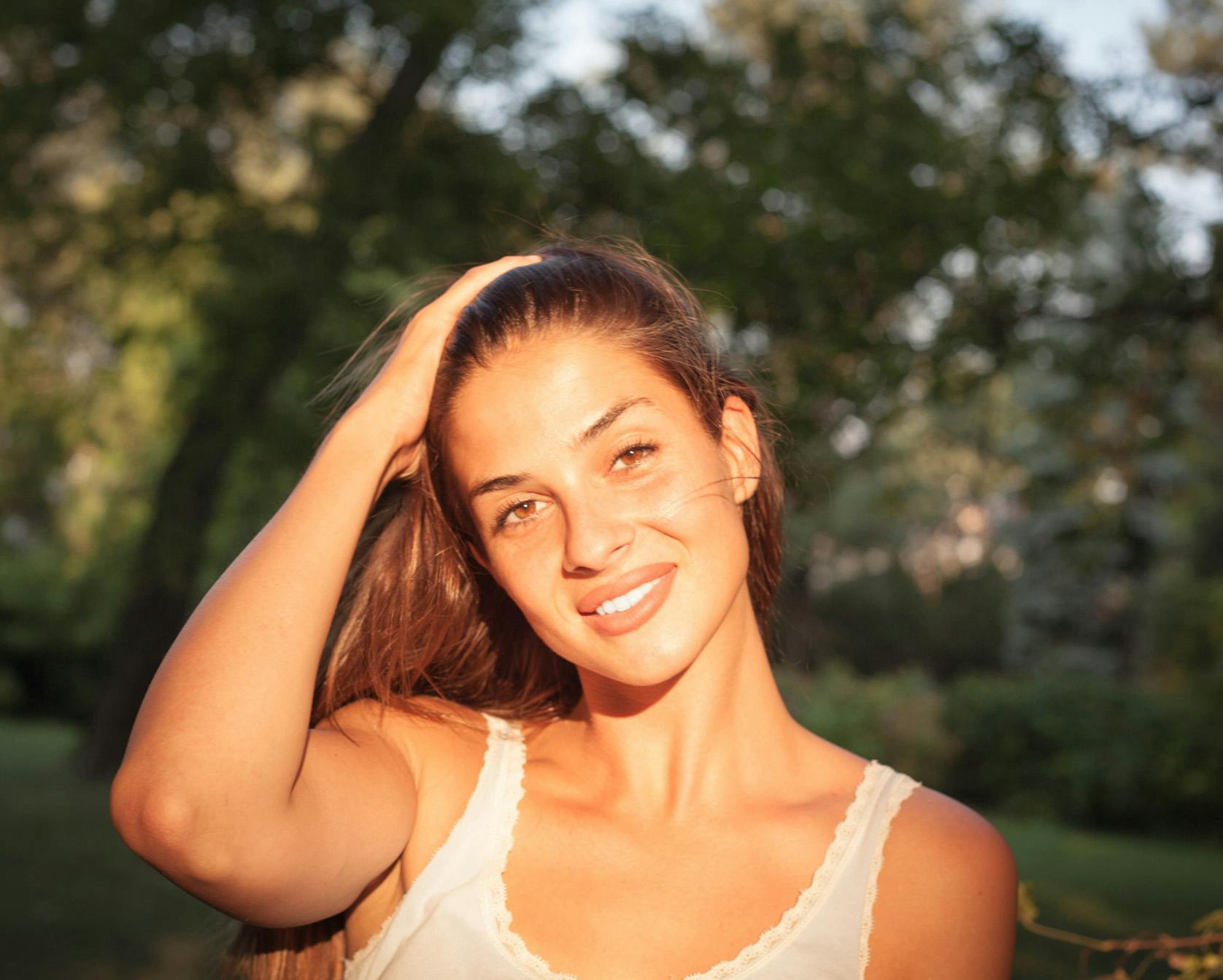 Woman with hand on her head and smiling
