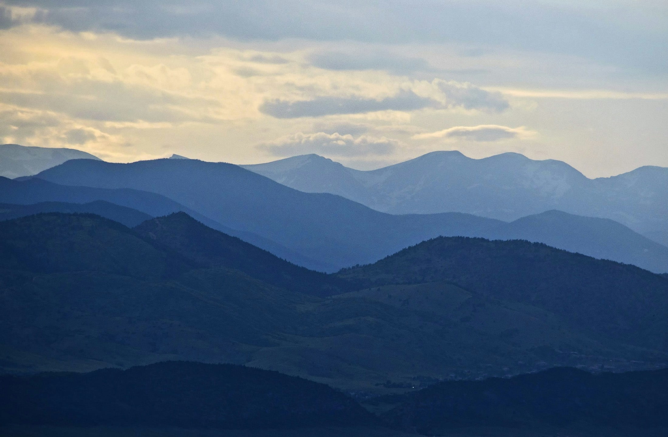 mountains with a few clouds in the sky