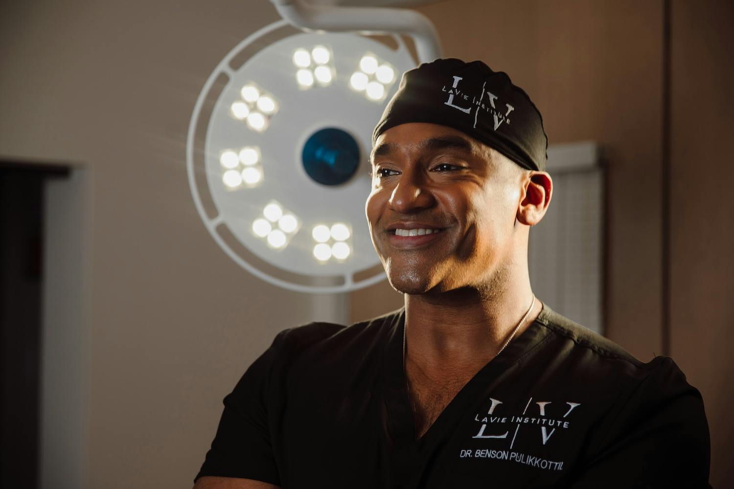 Dr. Benson Pulikkottil lavie plastic surgeon in black scrubs
