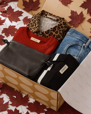 Lookiero autumn outfits selection: red jumper, leopard print shirt, blue jeans and black bag, autumn fashion ideas for women.