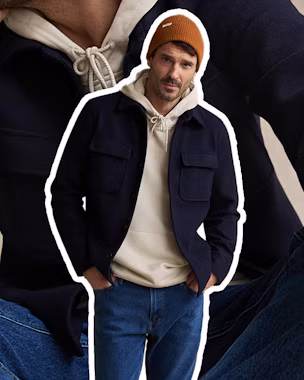 Men’s layered outfit with lightweight knitwear and outerwear showing how to stay warm without looking bulky.