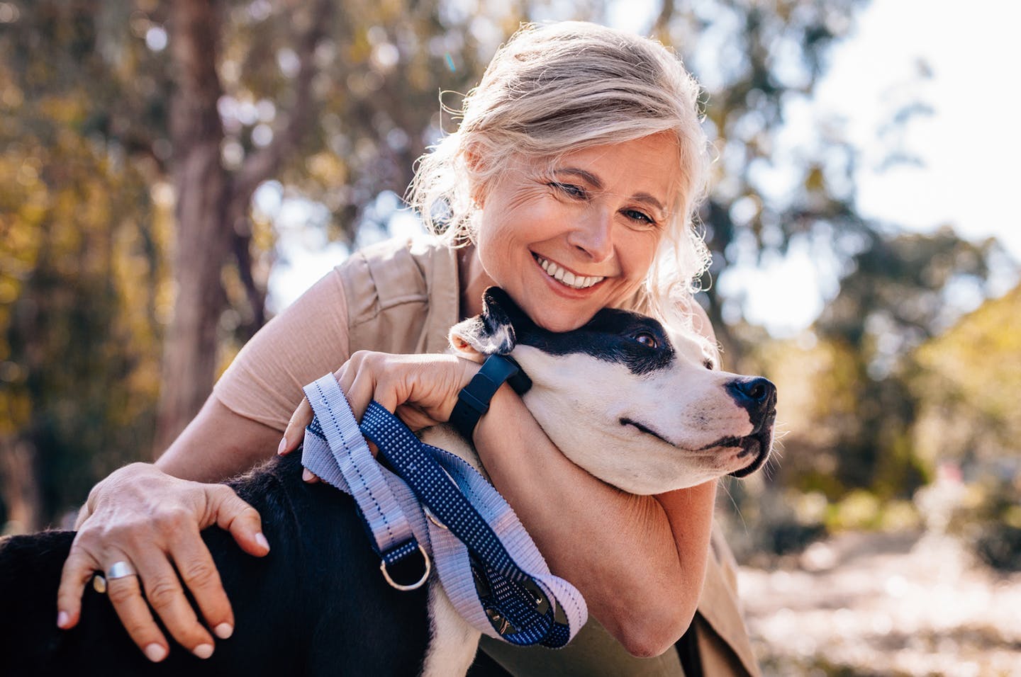 woman hugging her dog outside