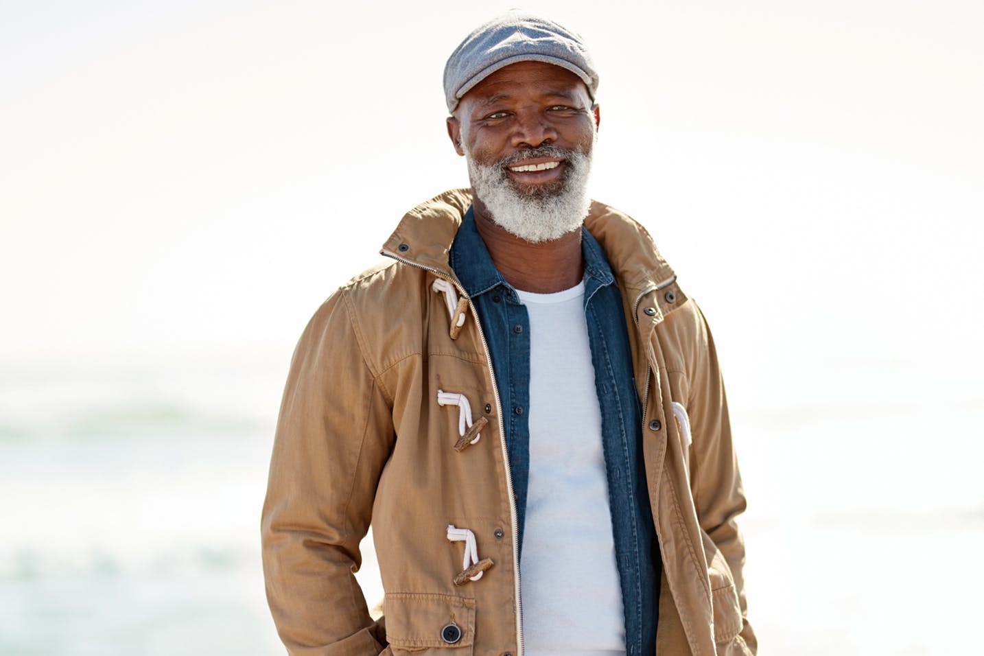 man in hat smiling with a jacket on